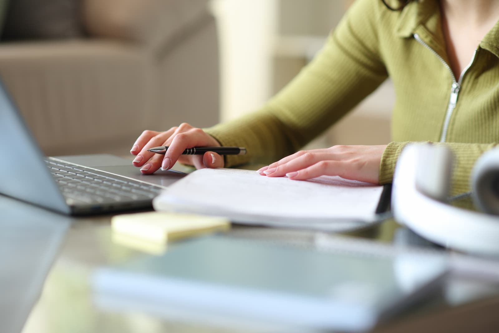 Woman researching and comparing psychiatrists on a laptop at home
